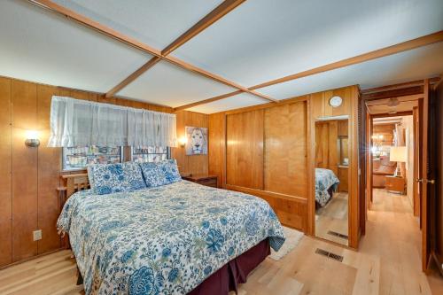 a bedroom with a bed with a blue and white bedspread at Pet-Friendly Yuma Vacation Rental with Pool Access! in Yuma