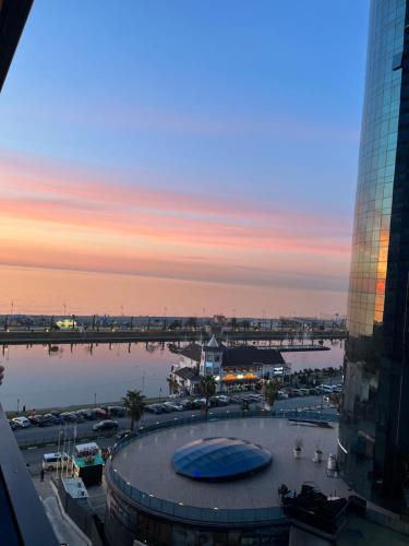 a view of a marina at sunset from a building at ORBI CITY lux studio apartment in Batumi