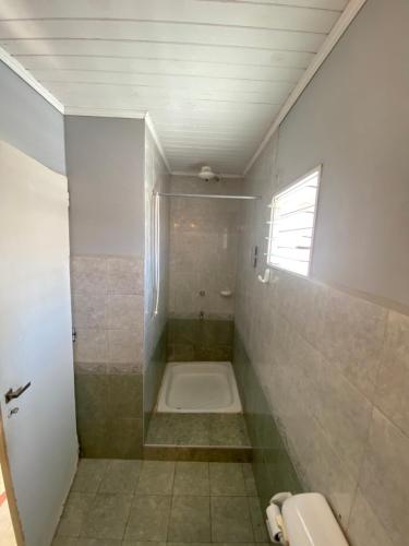 a bathroom with a shower and a tub in it at Monoambiente con terraza cerca de todo in Corrientes