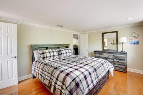 a bedroom with a bed and a mirror in it at Clearwater Vacation Home Rental with Tiki Bar! in Clearwater