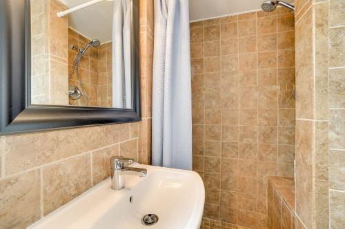 a bathroom with a sink and a mirror at Clearwater Vacation Home Rental with Tiki Bar! in Clearwater