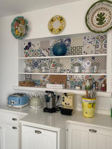 a kitchen with blue and white dishes on shelves at La Baia di Napoli in Capri