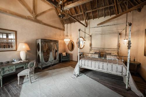 a bedroom with a bed and a desk in a room at Balquisse Heritage Hotel in Jimbaran
