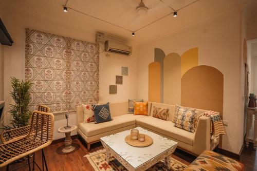 a living room with a couch and a table at Aloha Ganga view 2BHK Apartment by Almost Heaven in Rishīkesh