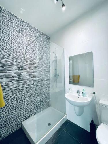 a bathroom with a glass shower and a sink at Modern St.Julian's Heart 2 Bed 2 Bath | Paceville in St. Julianʼs