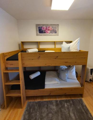 a bunk bed with white pillows at Kozma Apartments Peterlewand Gerlitzen Ossiachersee in Bodensdorf