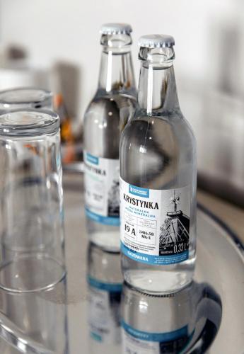 three bottles of water are sitting on a tray at Villa AdaMar - masaże & jacuzzi in Ciechocinek