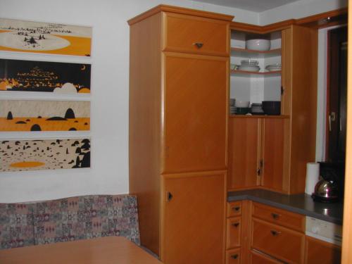 a large wooden cabinet in a kitchen with a table at Haus Polly in Strasshof an der Nordbahn