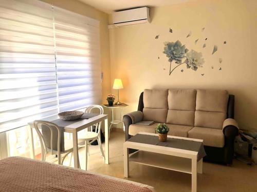 sala de estar con sofá y mesa en Estudio 4 en playa del Palo en Málaga