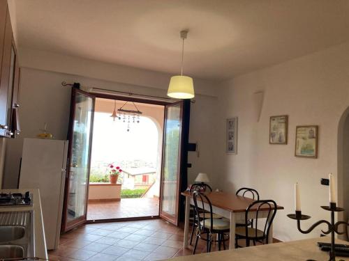 a kitchen and dining room with a table and chairs at Villa Stefania in Marina di Camerota