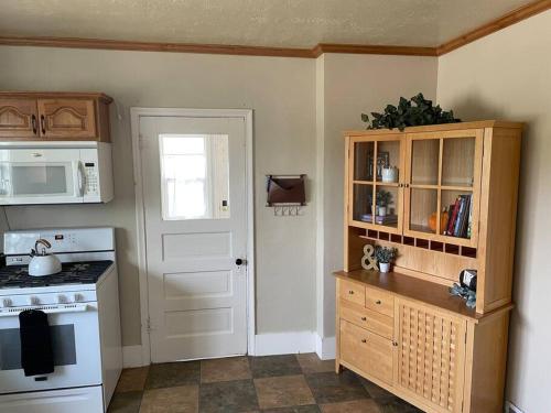 a kitchen with a white stove and a white door at Maple Canyon*Pet-friendly fenced yard*RV Parking in Moroni