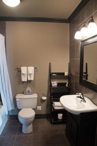 a bathroom with a toilet and a sink at Monastery Hotel in St. John's