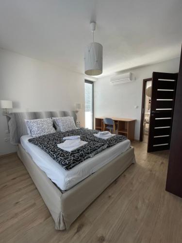 een slaapkamer met een groot bed en een tafel bij Apartmány Diamant in Bratislava
