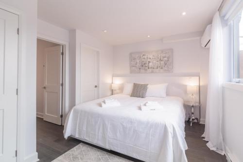 Cama ou camas em um quarto em Parc Avenue Residences Mile End