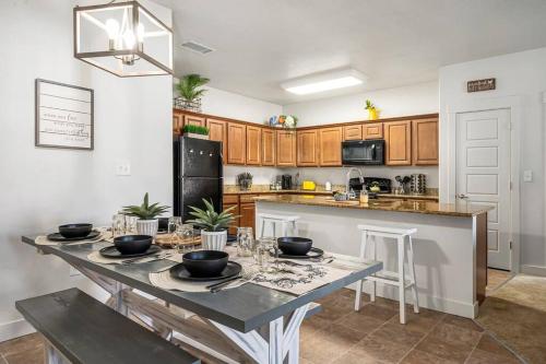 a kitchen with a table with bowls on it at Bee Chic in SoJo w/hot tub+gym+local ski slopes in South Jordan