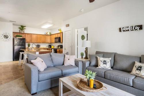 a living room with a couch and a table at Bee Chic in SoJo w/hot tub+gym+local ski slopes in South Jordan