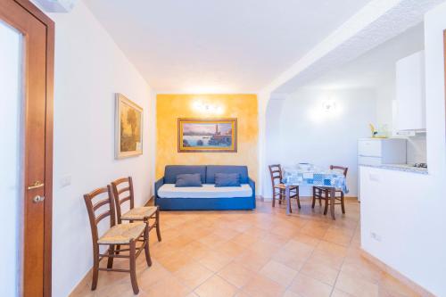 a living room with a couch and a table and chairs at CASA VACANZA IL PORTICO in Moneglia