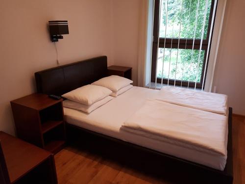 a bed with two pillows on it in a bedroom at Villa VIP Jurata in Jurata