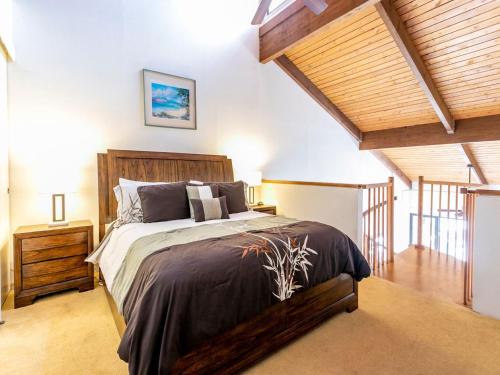 a bedroom with a large bed in a room with wooden ceilings at Kamaole Sands 8-402 - 2 Bedrooms, Pool Access, Spa, Sleeps 6 in Wailea