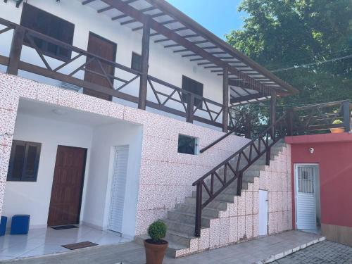 a house with a staircase on the side of it at Pousada Canto Juquehy in Juquei