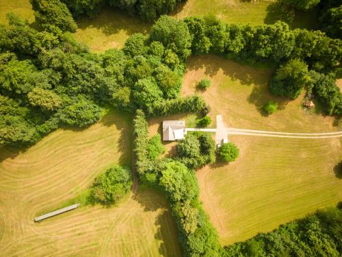 an aerial view of a field with trees and a house at Čebelnk: sanjska hišica 4 km od Bleda in Lesce