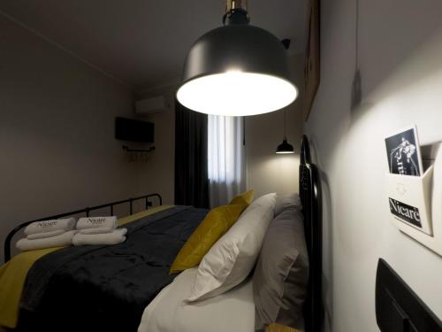 Postel nebo postele na pokoji v ubytování Nicarè Rooms