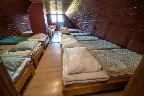 A bed or beds in a room at Ruška koča