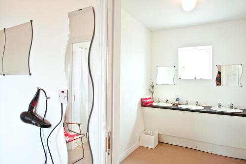 a bathroom with two sinks and a mirror at Portsalon Luxury Camping in Portsalon