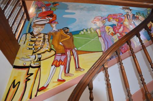 a mural on the stairs of a house at Hotel le Faisan in Saint-Avertin