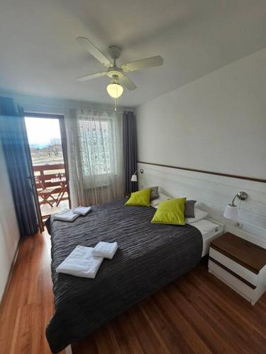 a bedroom with a bed with two towels on it at Bansko Private VIP Apartment in Bansko