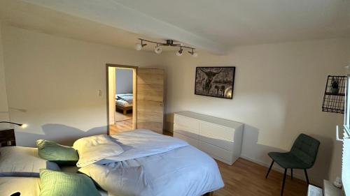 a bedroom with a large bed and a mirror at Heimatliebe Erfweiler Wohnung DREI in Erfweiler