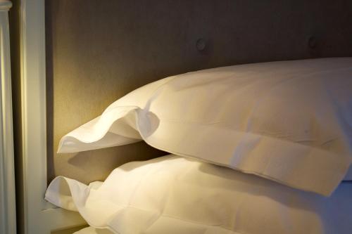 two pillows on a bed in a room at Parco dei Principi Boutique Hotel in Rimini