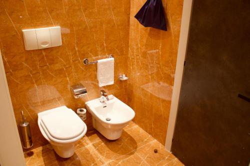 a bathroom with a toilet and a sink at Parco dei Principi Boutique Hotel in Rimini