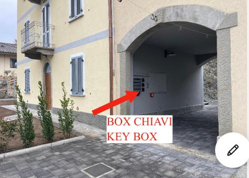 a building with a box chunky key box next to it at RIAREL- Foresteria Lombarda in Rodero