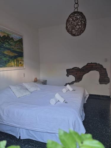 a bedroom with a bed with two towels on it at Yunga in Salta