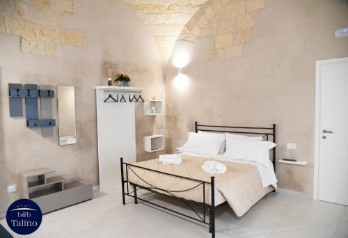 a bedroom with a large bed with white pillows at B&B Talino in Trani