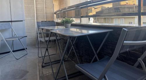 a bar with two tables and a chair at ALBACETE CENTRO PARKING GRATIS 2 PLAZAS in Albacete