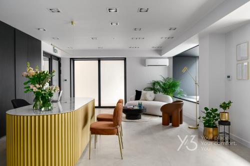 a living room with a yellow counter and a couch at Saint Martin Residence Old Town with Wellness in Poznań