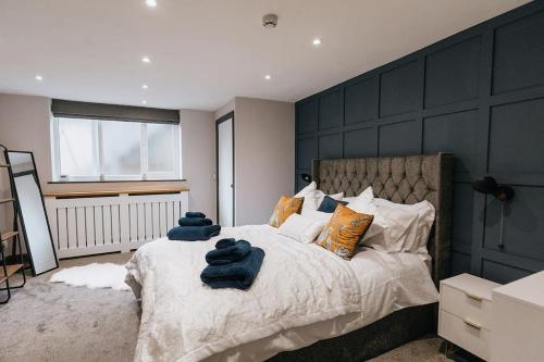 a bedroom with a large bed with blue towels on it at GROVE HOUSE NO.07 - Luxury Apartment close to the Llandudno Beach in Llandudno