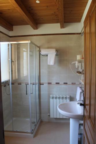 a bathroom with a shower and a sink at Hotel Rural Rio Molinar in Ranera