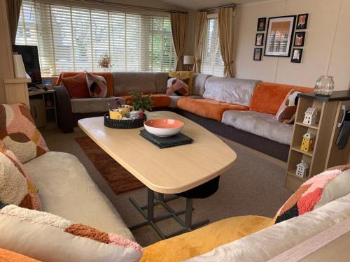 a living room with a couch and a table at Tyn llan in Llanddeusant