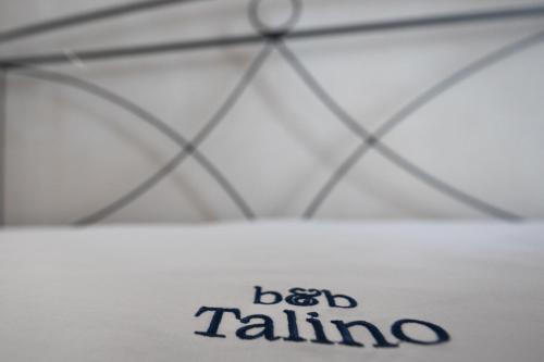 a white shirt with the words bad falling written on it at B&B Talino in Trani