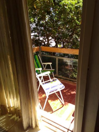 a porch with two lawn chairs on a deck at Monoambiente céntrico con balcón - Posadas, Misiones in Posadas