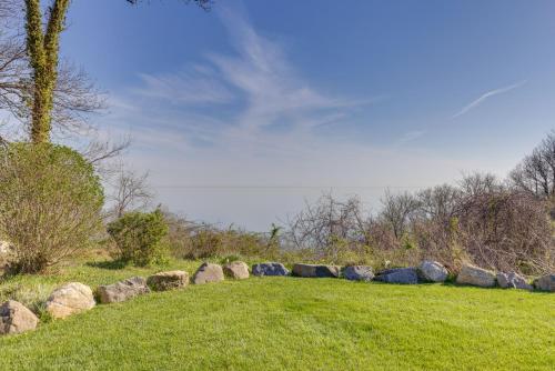 a row of rocks in a grassy field at Amazing Rocky Point Retreat Overlooking the Sound! in Rocky Point