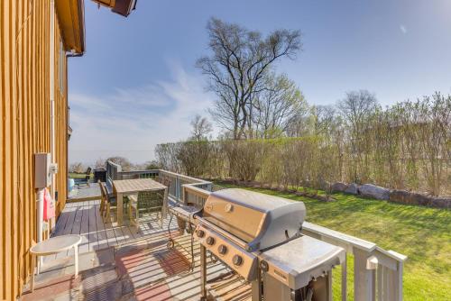 a patio with a grill and a table on a deck at Amazing Rocky Point Retreat Overlooking the Sound! in Rocky Point