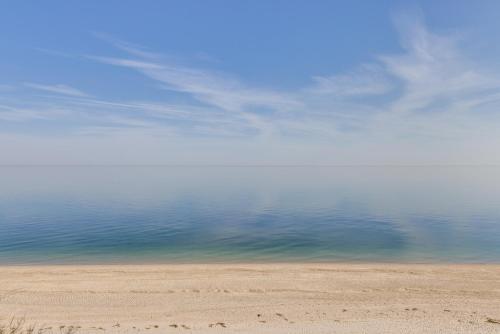 a view of the ocean from a sandy beach at Amazing Rocky Point Retreat Overlooking the Sound! in Rocky Point