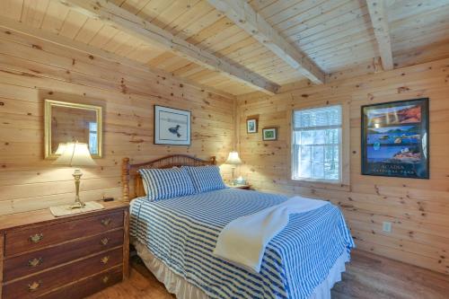 a bedroom with a bed in a log cabin at Maine Lodging Near Acadia National Park! in Bernard