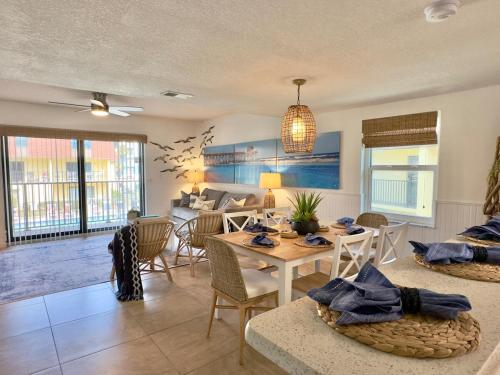 a living room with a table and chairs at Pier Pressure Beachfront Wpool in Cocoa Beach