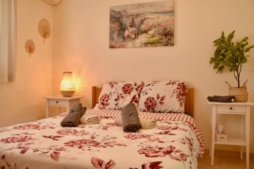 a bedroom with a bed with a comforter on it at Pervolina countryside by the sea in Pervolia