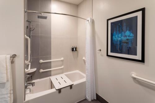 a bathroom with a shower and a sink at Running Aces Hotel & Casino, Trademark Collection by Wyndham in Forest Lake